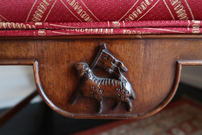 Wooden carving of lamb and flag St John's College Oxford